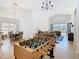 Open floor plan with foosball table, dining area, living room, and view to the pool at 631 Tuscan Hills Blvd, Davenport, FL 33897