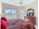 Well-lit main bedroom with ceiling fan, ensuite access, and a serene view of the pool at 631 Tuscan Hills Blvd, Davenport, FL 33897
