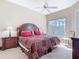 Spacious main bedroom with large window, ceiling fan, and neutral carpet at 631 Tuscan Hills Blvd, Davenport, FL 33897