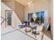 Inviting covered patio with comfortable seating, perfect for relaxation, complemented by a ceiling fan at 631 Tuscan Hills Blvd, Davenport, FL 33897