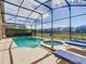 Sparkling pool with an attached spa, set within a screened enclosure and comfortable lounge chairs at 631 Tuscan Hills Blvd, Davenport, FL 33897