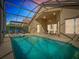 Relaxing screened-in pool with chairs and outdoor seating, perfect for enjoying the beautiful weather at 631 Tuscan Hills Blvd, Davenport, FL 33897