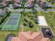 Overhead shot of a community tennis court, beach volleyball court and playground at 631 Tuscan Hills Blvd, Davenport, FL 33897