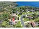 Aerial view of the property highlighting the lake views, lush greenery, pool, big yard, and neighborhood layout at 743 Mills Estate Pl, Chuluota, FL 32766