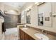 Bathroom featuring granite countertops, double sinks, and a tiled shower/tub for a luxurious feel at 743 Mills Estate Pl, Chuluota, FL 32766