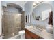 Bathroom featuring granite countertops, a sink, a mirror, and a glass shower room at 743 Mills Estate Pl, Chuluota, FL 32766