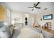 Stylish bedroom featuring a ceiling fan, television, wood floors, and a modern glass desk at 743 Mills Estate Pl, Chuluota, FL 32766
