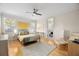 Comfortable bedroom with hardwood floors, large windows, and neutral decor at 743 Mills Estate Pl, Chuluota, FL 32766