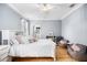 Bright bedroom featuring a ceiling fan, hardwood flooring, and a walk-in closet at 743 Mills Estate Pl, Chuluota, FL 32766
