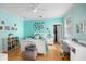 Cozy, blue bedroom with a ceiling fan, workstation, and closet perfect for a or teen at 743 Mills Estate Pl, Chuluota, FL 32766