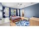 Comfortable bedroom features a ceiling fan, windows, and blue walls, creating a cozy and productive space at 743 Mills Estate Pl, Chuluota, FL 32766