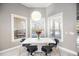 A bright dining nook features modern decor, multiple windows, and a vase of red flowers at 743 Mills Estate Pl, Chuluota, FL 32766