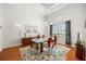 This dining room showcases modern lighting, a glass dining table, and hardwood floors for elegant gatherings at 743 Mills Estate Pl, Chuluota, FL 32766