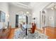This dining room showcases hardwood floors, a glass dining table, and modern lighting for an ideal entertainment space at 743 Mills Estate Pl, Chuluota, FL 32766