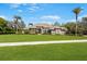 Stately home showcasing a lush green lawn, mature trees, and meticulous landscaping, creating a welcoming curb appeal at 743 Mills Estate Pl, Chuluota, FL 32766
