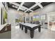 Bright game room features a pool table, stylish decor, and access to outdoor living space at 743 Mills Estate Pl, Chuluota, FL 32766