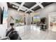 Spacious game room includes a modern arcade machine and access to an outdoor pool area at 743 Mills Estate Pl, Chuluota, FL 32766