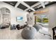 Bright game room features a TV, exercise equipment, lounge seating and access to outdoor pool at 743 Mills Estate Pl, Chuluota, FL 32766