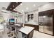 Well-lit kitchen boasts an island with a sink, barstool seating, and stainless steel appliances at 743 Mills Estate Pl, Chuluota, FL 32766