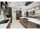Modern kitchen with stainless steel appliances, custom cabinets and large island with sink at 743 Mills Estate Pl, Chuluota, FL 32766
