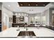 Bright kitchen with a large center island with stainless steel sink and modern lighting fixtures at 743 Mills Estate Pl, Chuluota, FL 32766