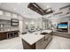 Open kitchen showcasing a large island, stainless steel sink, and views of the living area at 743 Mills Estate Pl, Chuluota, FL 32766