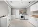 Spacious laundry room with a sink, modern washer and dryer, storage, and natural light at 743 Mills Estate Pl, Chuluota, FL 32766