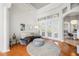 Bright living room with hardwood floors, large windows, and elegant furniture at 743 Mills Estate Pl, Chuluota, FL 32766