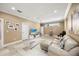 Spacious living room with tile floors, a large TV, and a comfortable leather sofa at 743 Mills Estate Pl, Chuluota, FL 32766