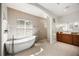 This luxurious main bathroom features a soaking tub, walk-in shower, and granite countertop vanity, for a peaceful space at 743 Mills Estate Pl, Chuluota, FL 32766