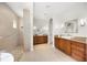 This bathroom offers and vanities with granite countertops, walk-in shower, and bright lights for morning convenience at 743 Mills Estate Pl, Chuluota, FL 32766