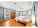 This bright main bedroom is well lit with an abundance of windows, providing relaxing natural light and showcasing the wood floors at 743 Mills Estate Pl, Chuluota, FL 32766