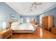Main bedroom with hardwood floors, ceiling fan, tray ceiling and beautiful decor at 743 Mills Estate Pl, Chuluota, FL 32766