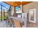 Outdoor kitchen boasts a grill, refrigerator, granite countertop, and bar seating at 743 Mills Estate Pl, Chuluota, FL 32766