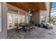 Covered patio features a dining area, fan, and lounge seating for relaxed outdoor living at 743 Mills Estate Pl, Chuluota, FL 32766