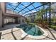 Covered pool area with a spa, tropical landscaping, and serene atmosphere at 743 Mills Estate Pl, Chuluota, FL 32766