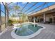 Screened-in pool area with lush landscaping, spa, and clear blue water at 743 Mills Estate Pl, Chuluota, FL 32766