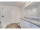 Bright bathroom boasts a double vanity with granite countertop, a shower, and modern fixtures at 815 Savona Pl, Kissimmee, FL 34758