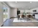 Bright dining area featuring a modern table, stylish chairs, and sliding glass doors to the backyard at 815 Savona Pl, Kissimmee, FL 34758