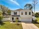 Charming two-story home featuring a well-maintained lawn, white picket fence and attached two car garage at 815 Savona Pl, Kissimmee, FL 34758
