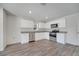 Bright kitchen with white cabinets, granite countertops, stainless steel appliances, and wood-look flooring at 815 Savona Pl, Kissimmee, FL 34758