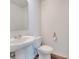 Well-lit powder room features a pedestal sink, modern fixtures, and stylish accents, offering convenience at 815 Savona Pl, Kissimmee, FL 34758