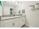 Clean, well-lit bathroom with double vanity sinks, gray countertops and Super Mario themed wall decor at 8959 Stinger Dr, Champions Gate, FL 33896