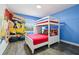 room with twin bunk bed, gray vinyl floors, Super Mario Brothers mural and great natural light at 8959 Stinger Dr, Champions Gate, FL 33896