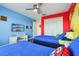Fun bedroom with two twin beds, television, video game console and bright Super Mario themed decor at 8959 Stinger Dr, Champions Gate, FL 33896