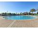 Expansive community pool area with lounge chairs, umbrellas, and a tiki bar at 8959 Stinger Dr, Champions Gate, FL 33896