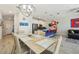 Bright dining area adjacent to the kitchen features a modern chandelier and seating for six at 8959 Stinger Dr, Champions Gate, FL 33896