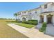 Charming townhouse exterior with well-kept landscaping and covered entryway on a sunny day at 8959 Stinger Dr, Champions Gate, FL 33896