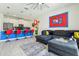 Open-concept living area with modern kitchen, gray sofa, and fun Mario-themed decor for a playful ambiance at 8959 Stinger Dr, Champions Gate, FL 33896