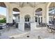 Covered outdoor dining area with a marble bar and ample seating arrangements at 8959 Stinger Dr, Champions Gate, FL 33896